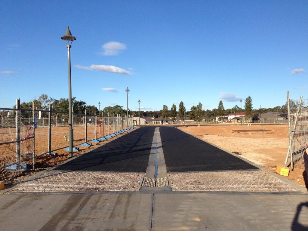 A Newly Repair Asphalt Road with Street Lights on Their Side — Sydney, Nsw — C & C Asphalt Pty Ltd