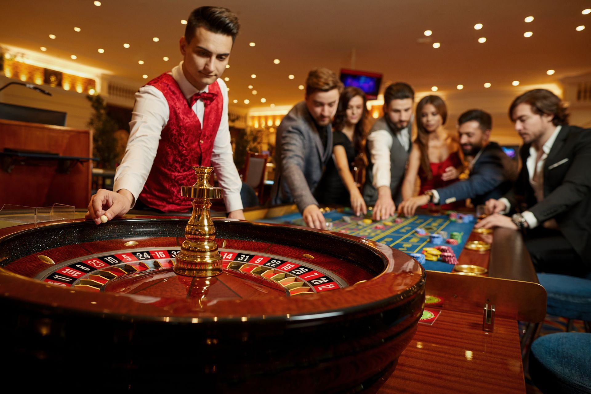 A group of people are playing roulette in a casino.