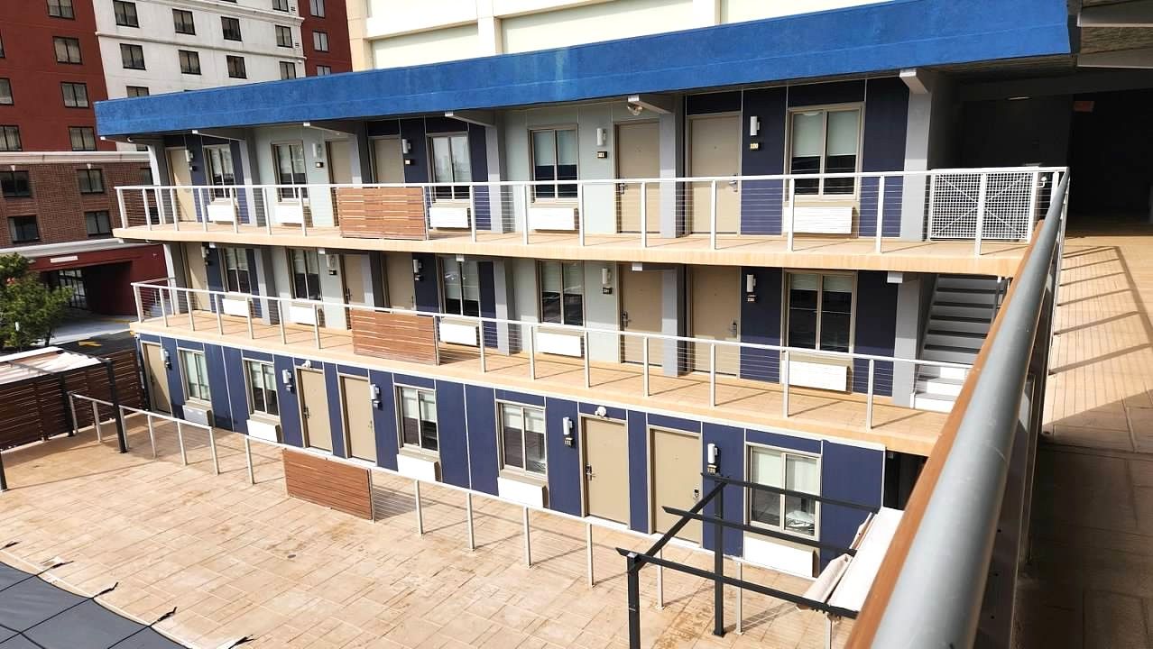 A large building with a blue roof and balconies