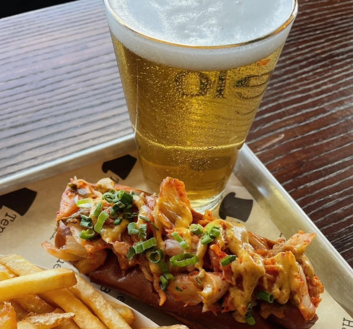 A close up of lobster roll and beer