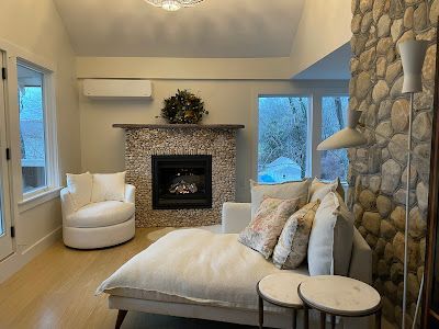A living room with a couch , chair , and fireplace.