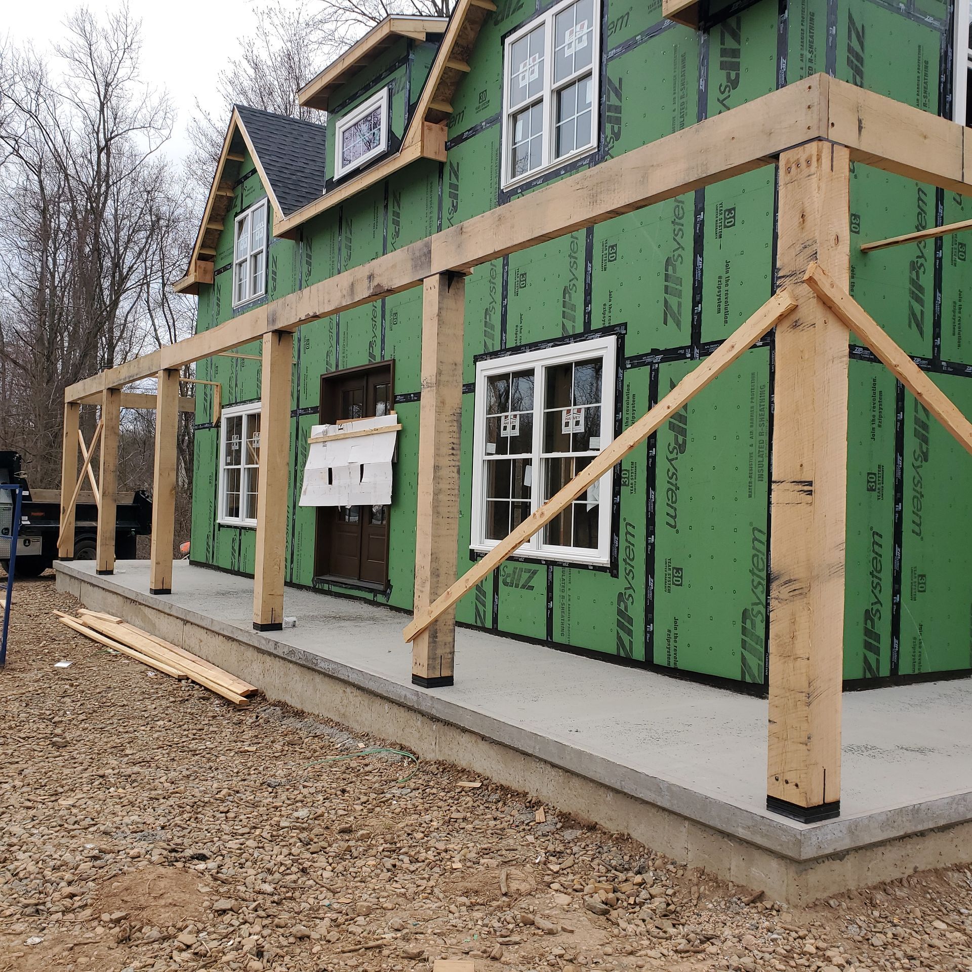 A house is being built with green insulation and wooden beams