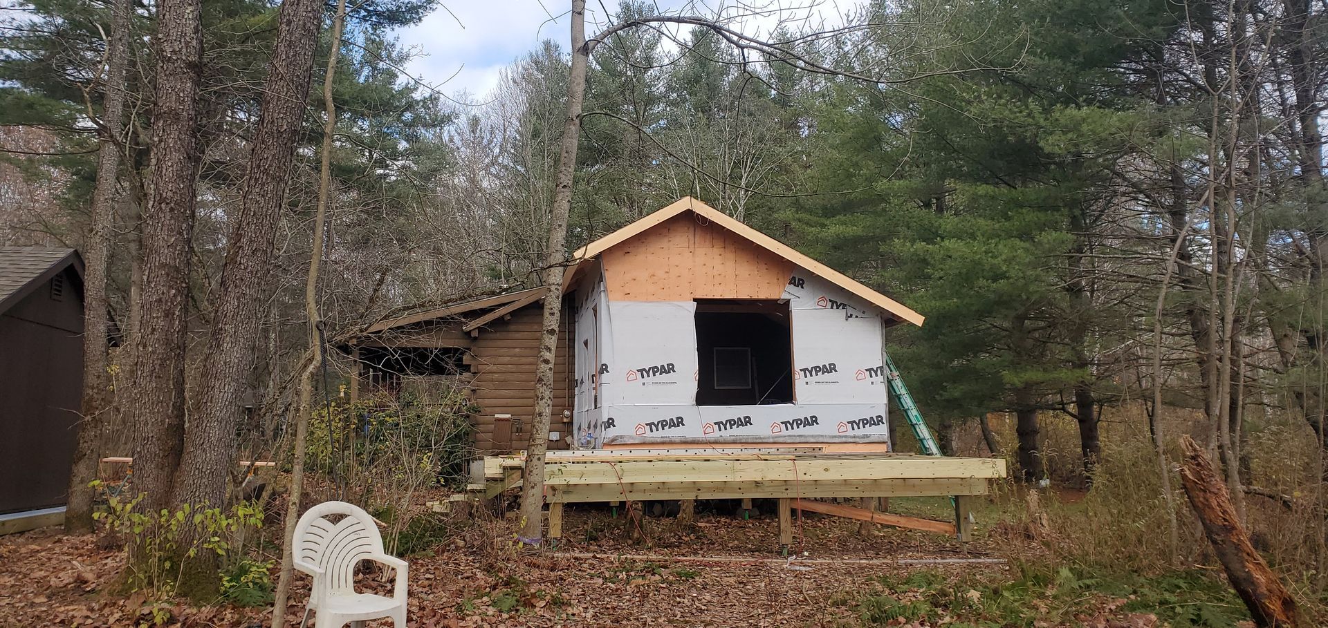 A small house is being built in the middle of a forest