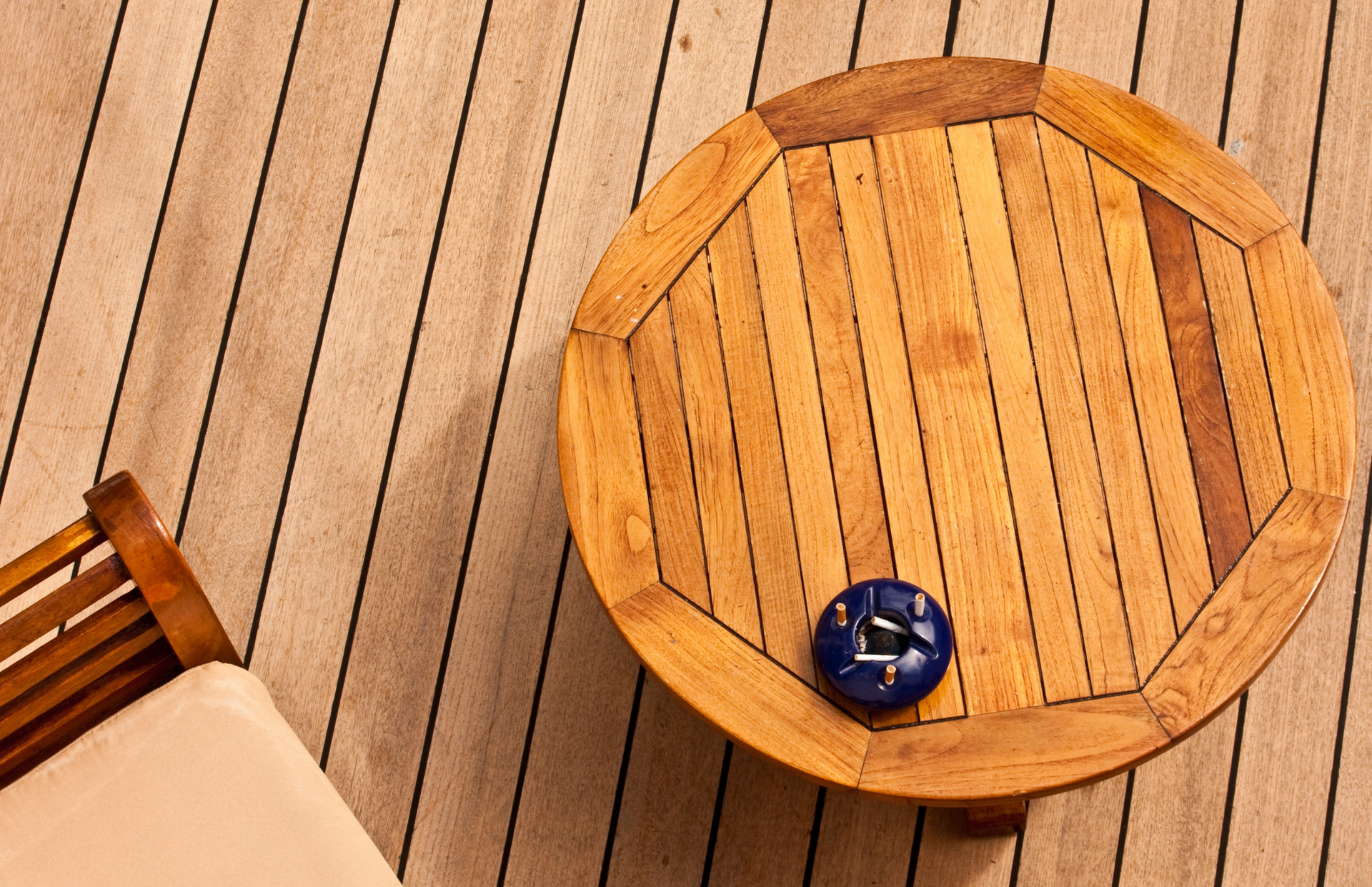 A wooden table with a blue clock on it