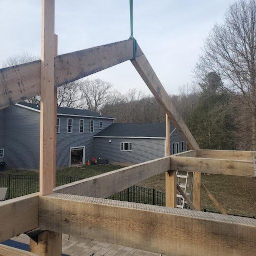 A wooden structure is being built in front of a house.