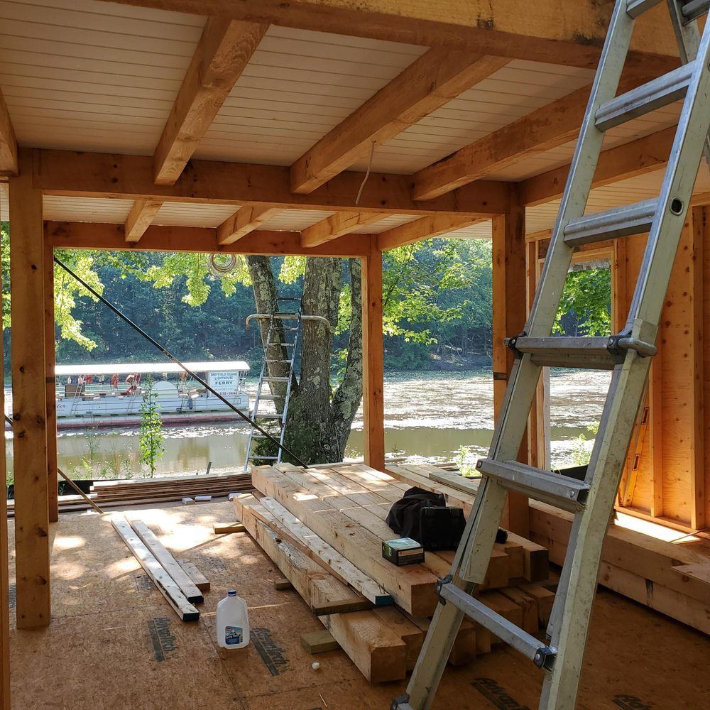 A ladder is in the middle of a wooden room
