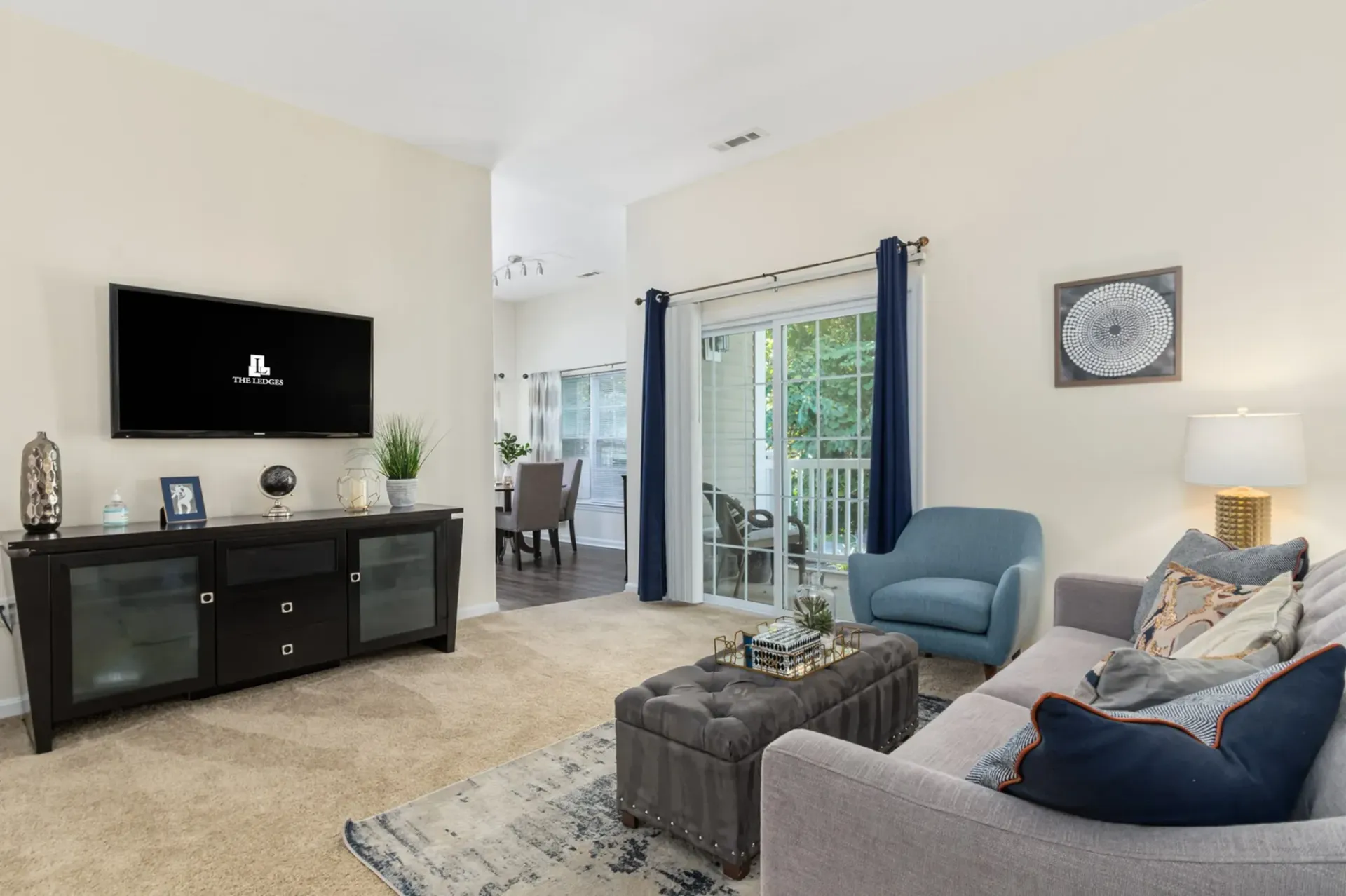 The Ledges at Johnston apartment living room with balcony.