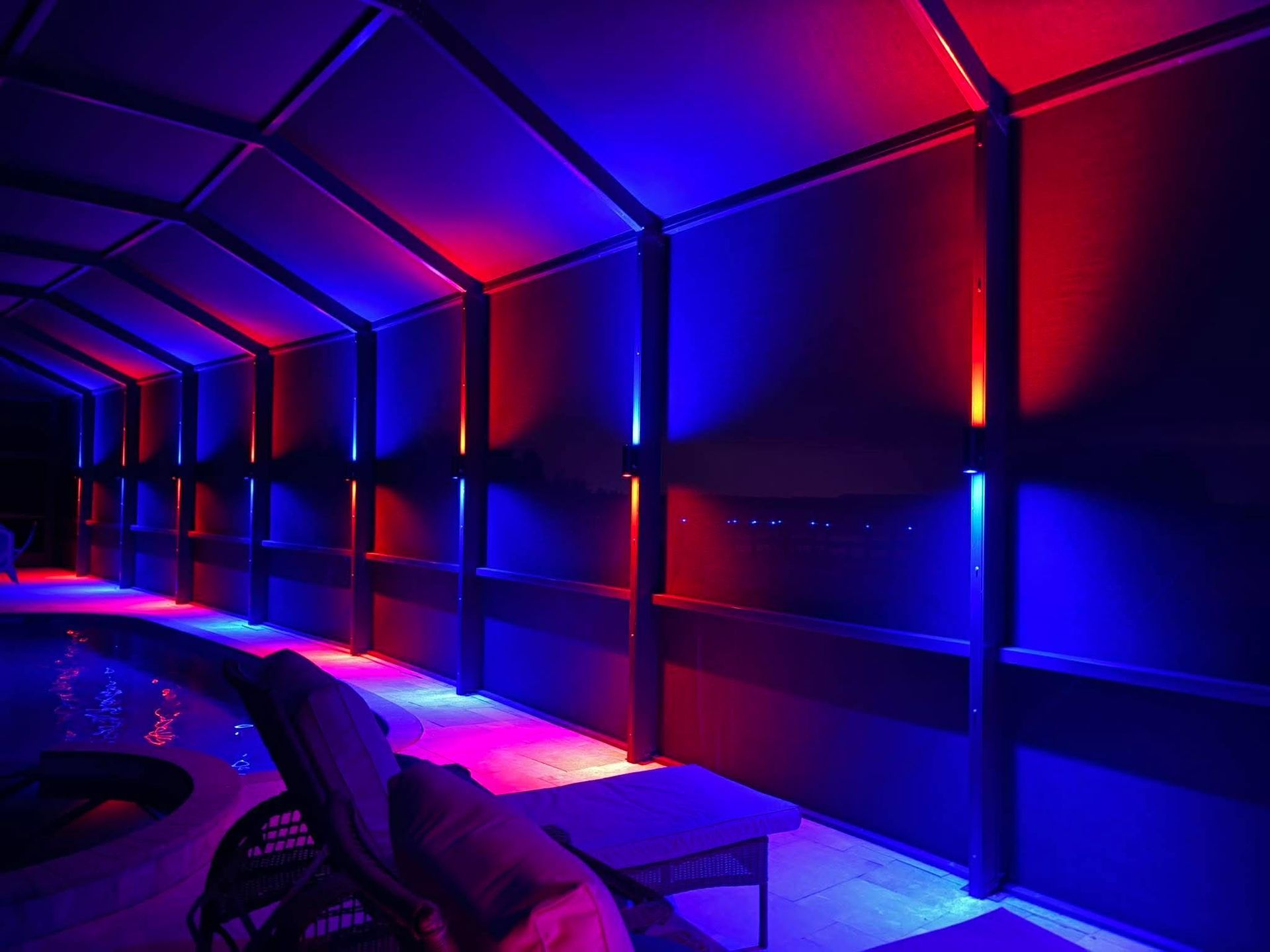 Neon-lit corridor with purple and red wall lights and curved benches along the side
