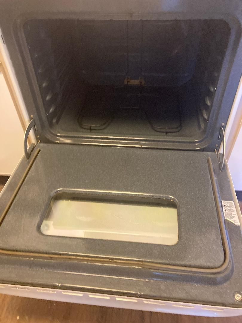 Open toaster oven with a baking tray inside