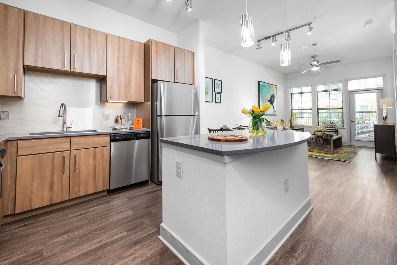Open-concept kitchen with wood cabinets, stainless-steel appliances, and an island.