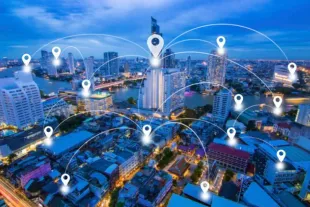 Futuristic city skyline at dusk with glowing location pins connected by arcs over buildings and waterfront