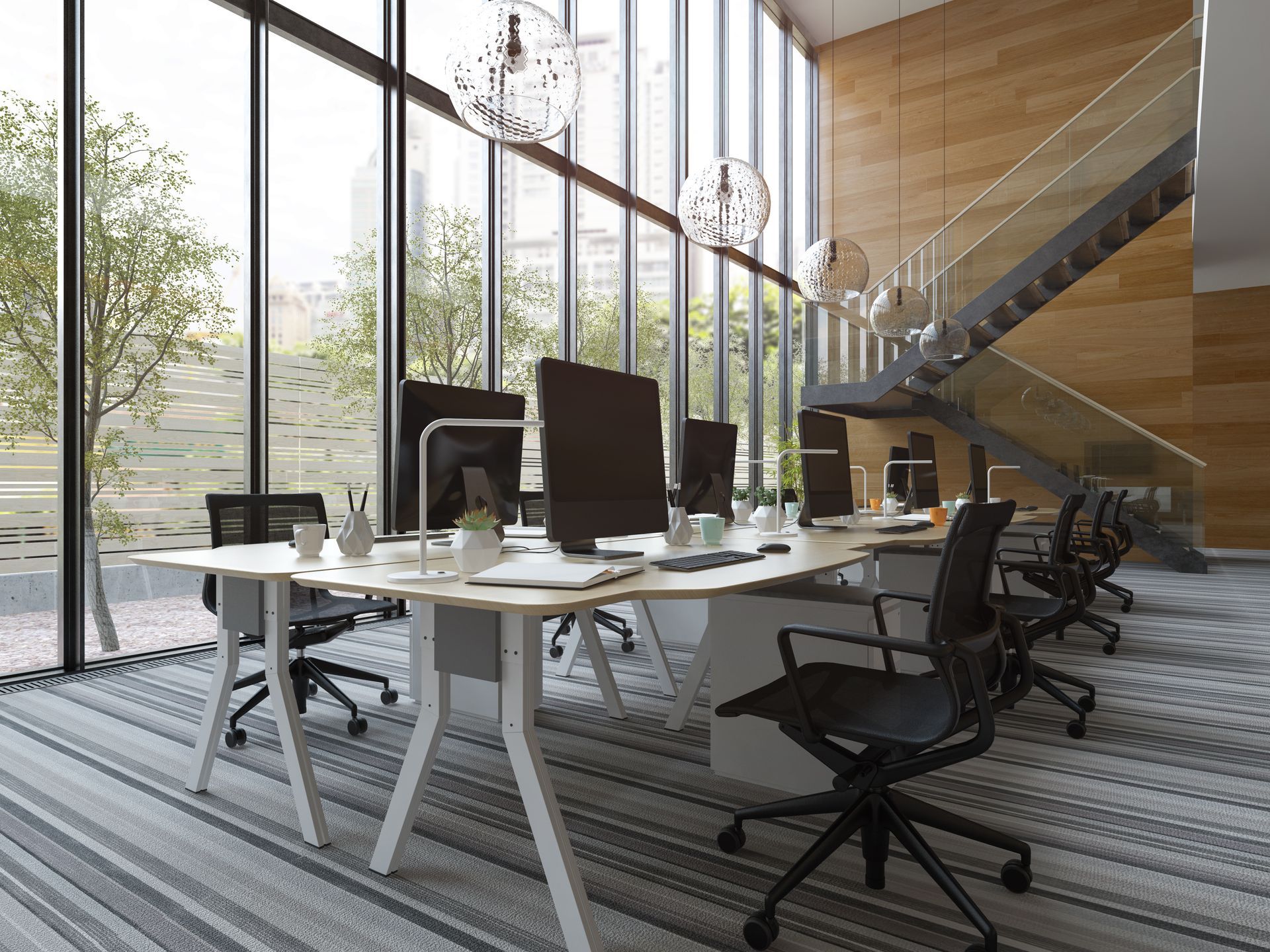 An empty office with a lot of windows and a staircase.