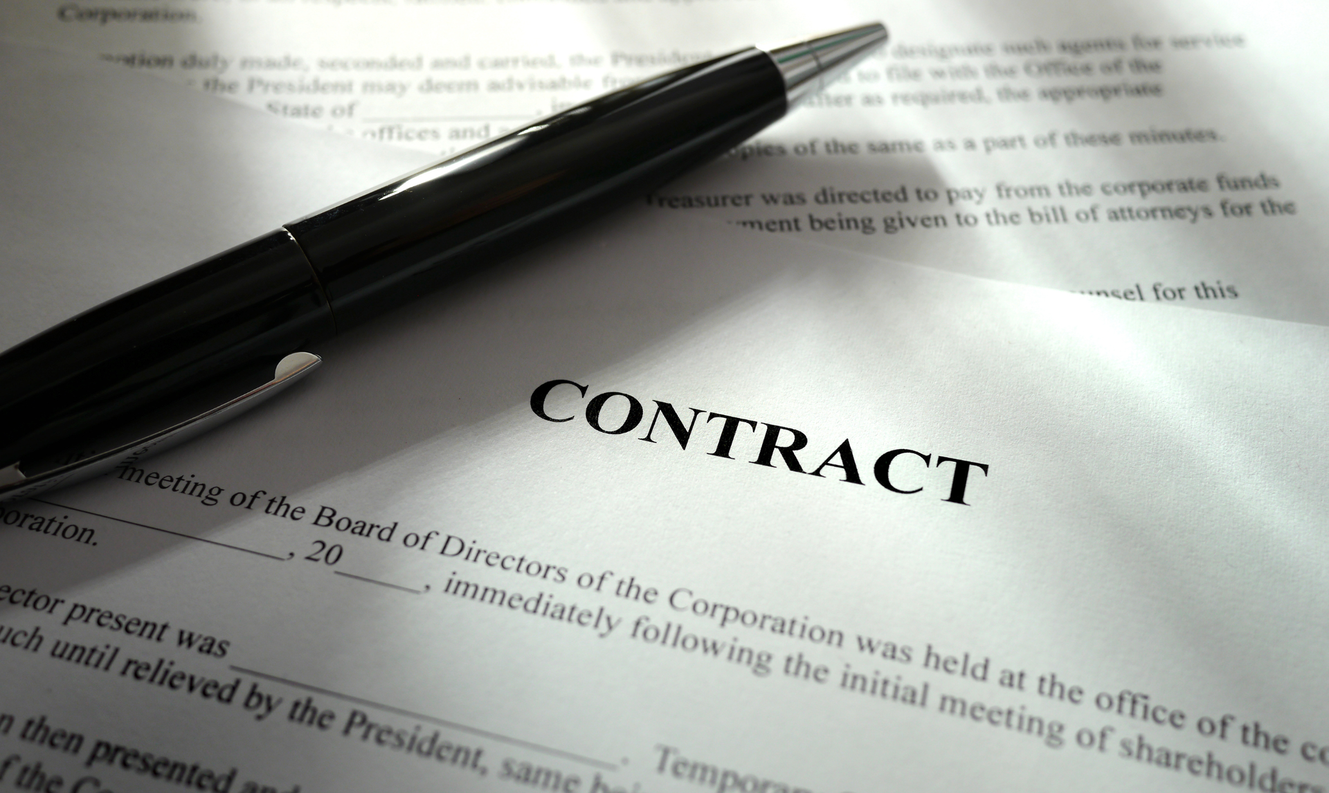 Contract document with a pen, ready to be signed.