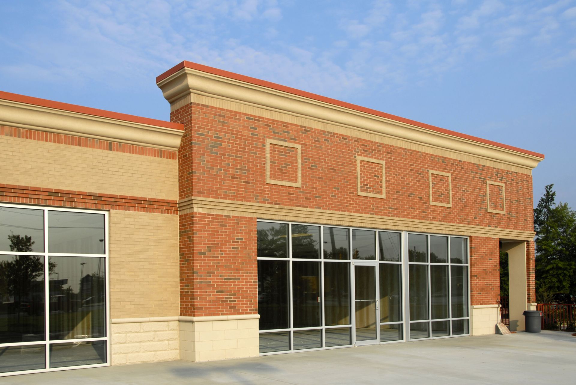 Street-level view of commercial building façade enhanced by reflective heat resistant film on glass. Street-level view of commercial building façade enhanced by reflective heat resistant film on glass.