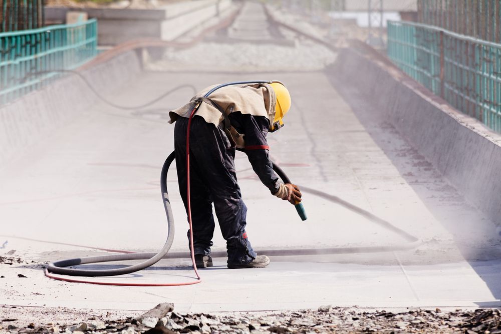 Worker in Protective Gear Sandblasting — Phoenix Protective & Marine Coating Specialists in Atherton Tablelands, QLD