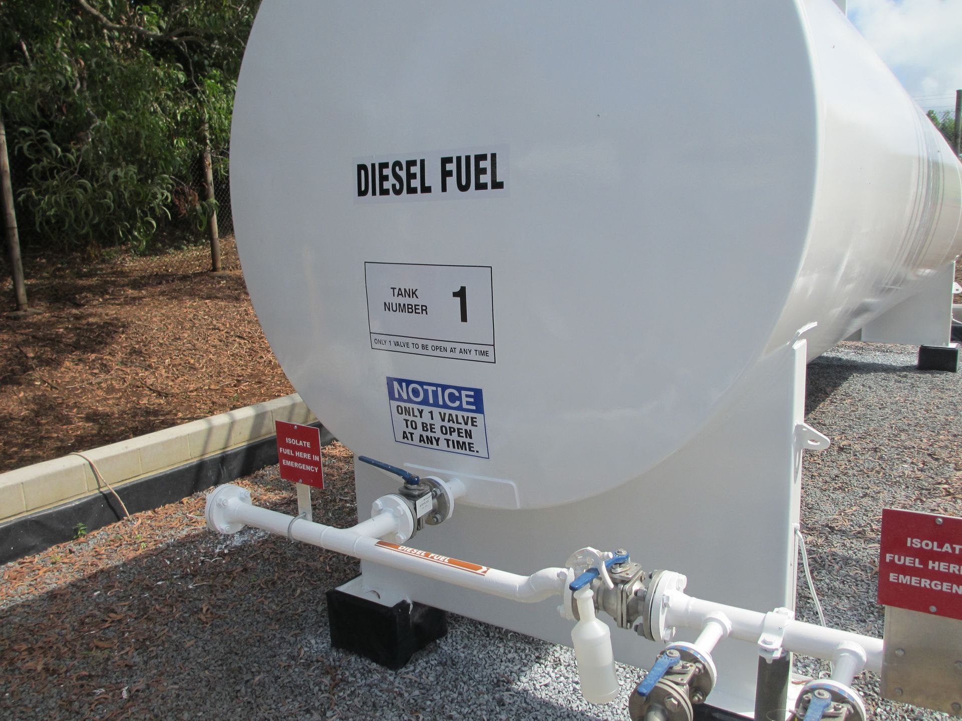 White Diesel Fuel Tank on Gravel With Pipes and Warning — Phoenix Protective & Marine Coating Specialists in Woree, QLD