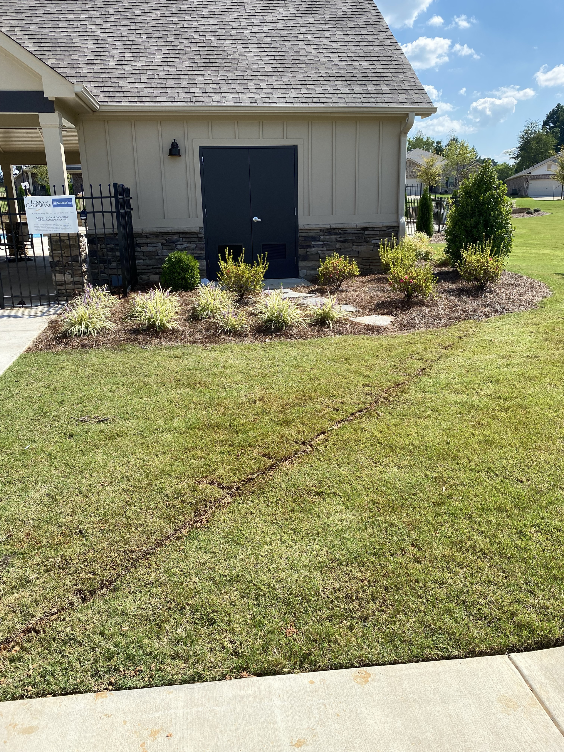 A house with a large lawn in front of it.