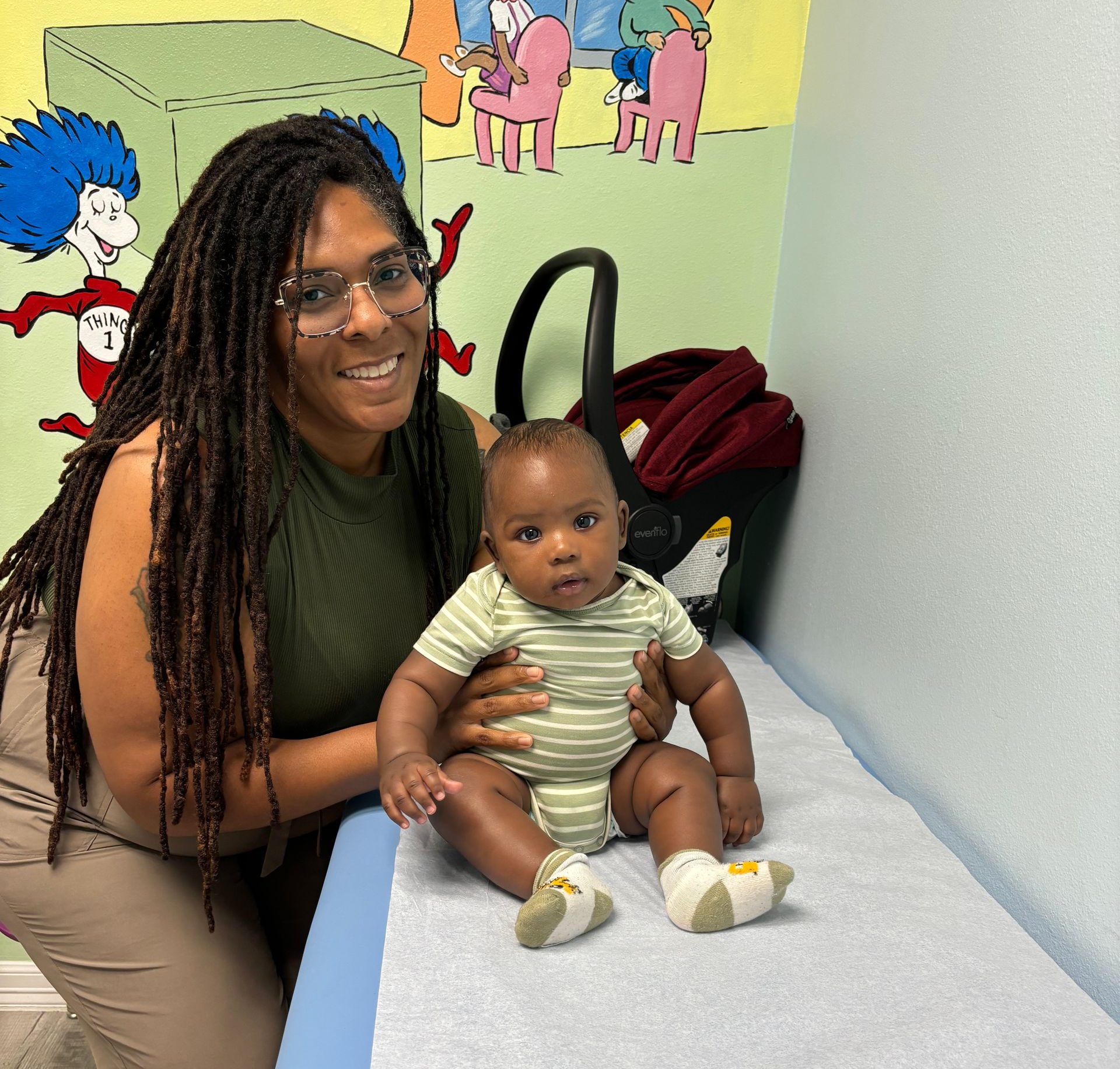 Adult with child receiving an injection from a gloved healthcare worker
