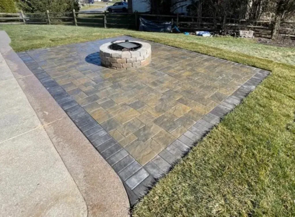 There is a fire pit in the middle of the patio.