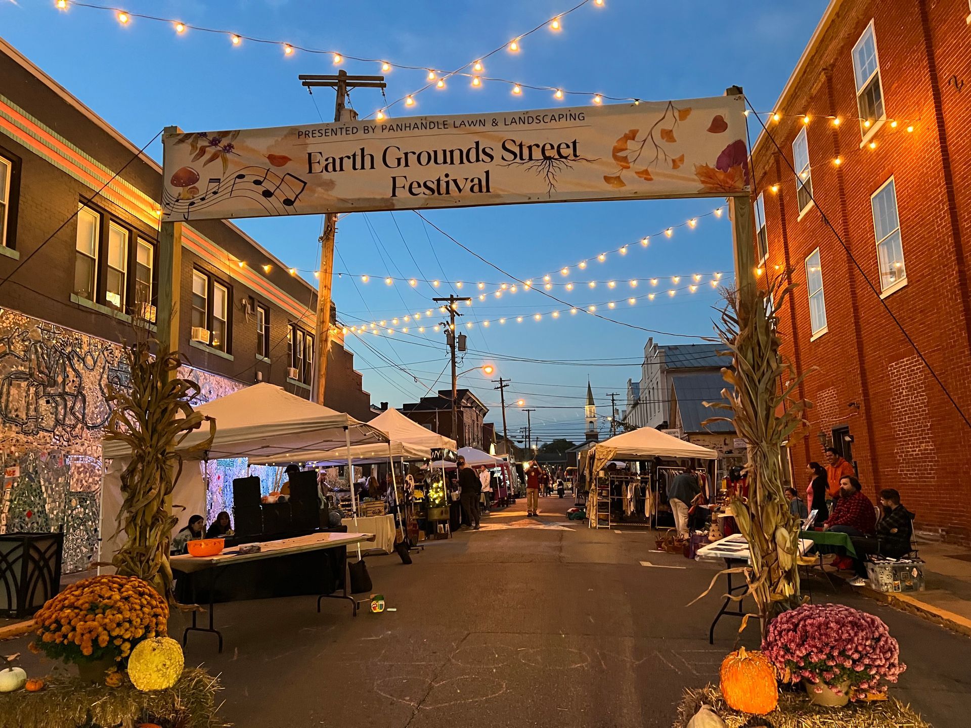 A street with a sign that says earth grounds street festival