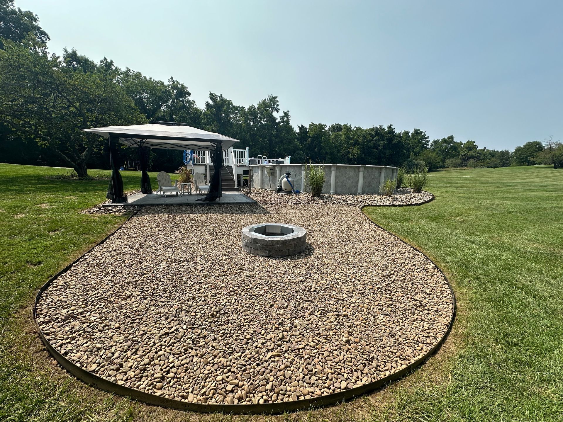 There is a fire pit in the middle of the yard.