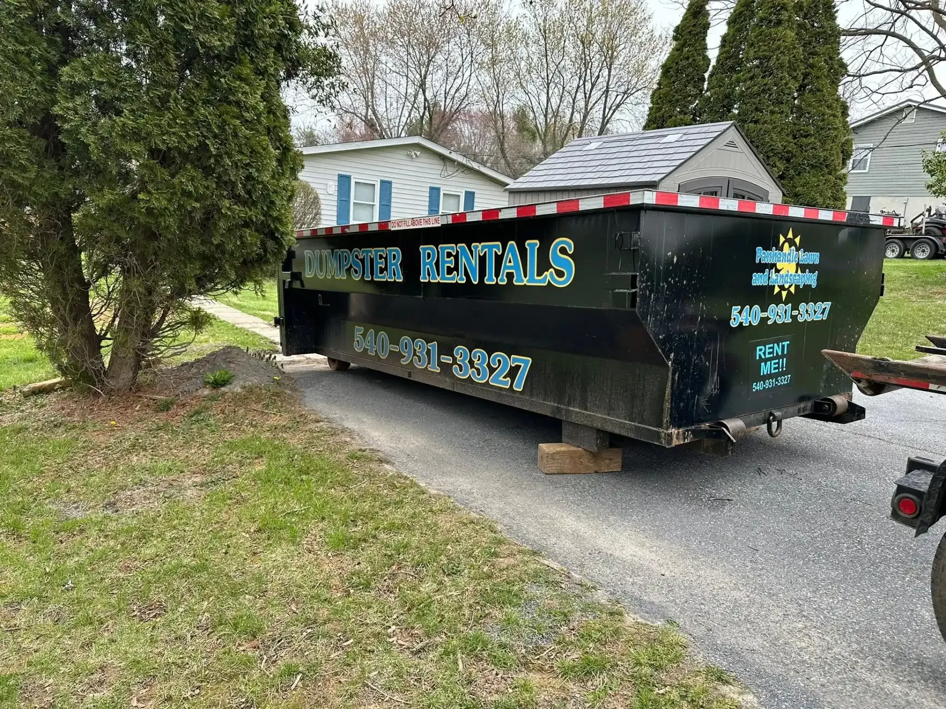 Earth Grounds Landscaping roll-off dumpster placed on a residential driveway in Charles Town, WV Dumpster Rental in Charles Town: Smart Loading and Planning Tips