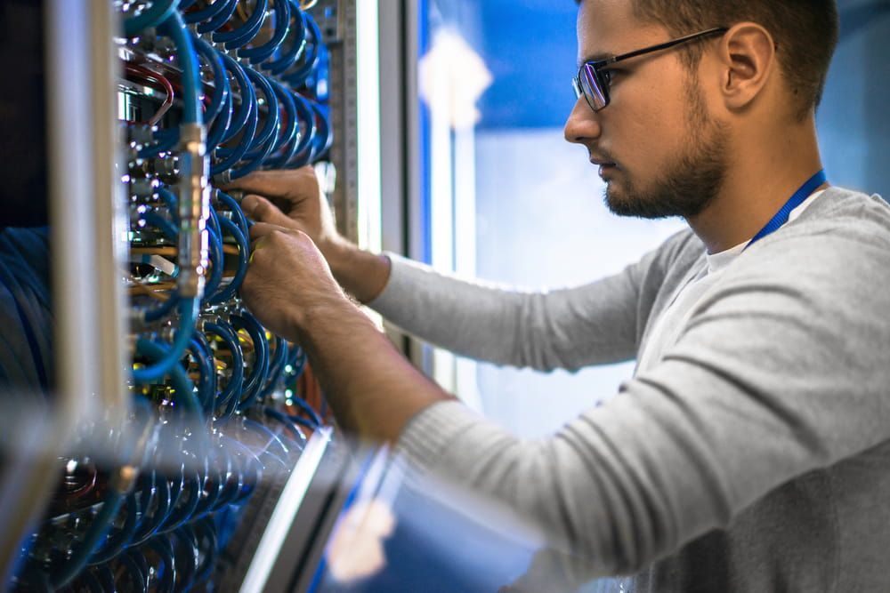 A Man Is Working On A Server In A Data Center — ActiveCo.IT in Forster, NSW