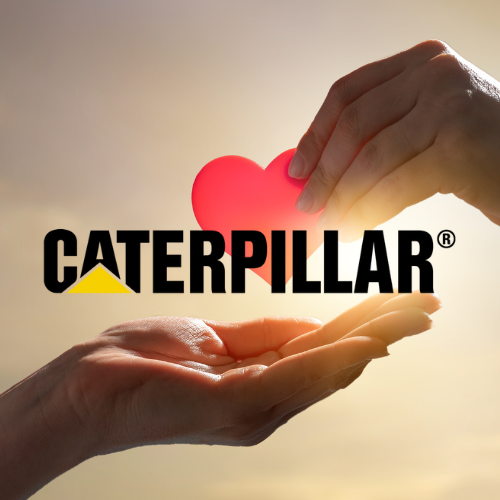 Hands sharing a pink heart, Caterpillar logo in front, golden sunset background.