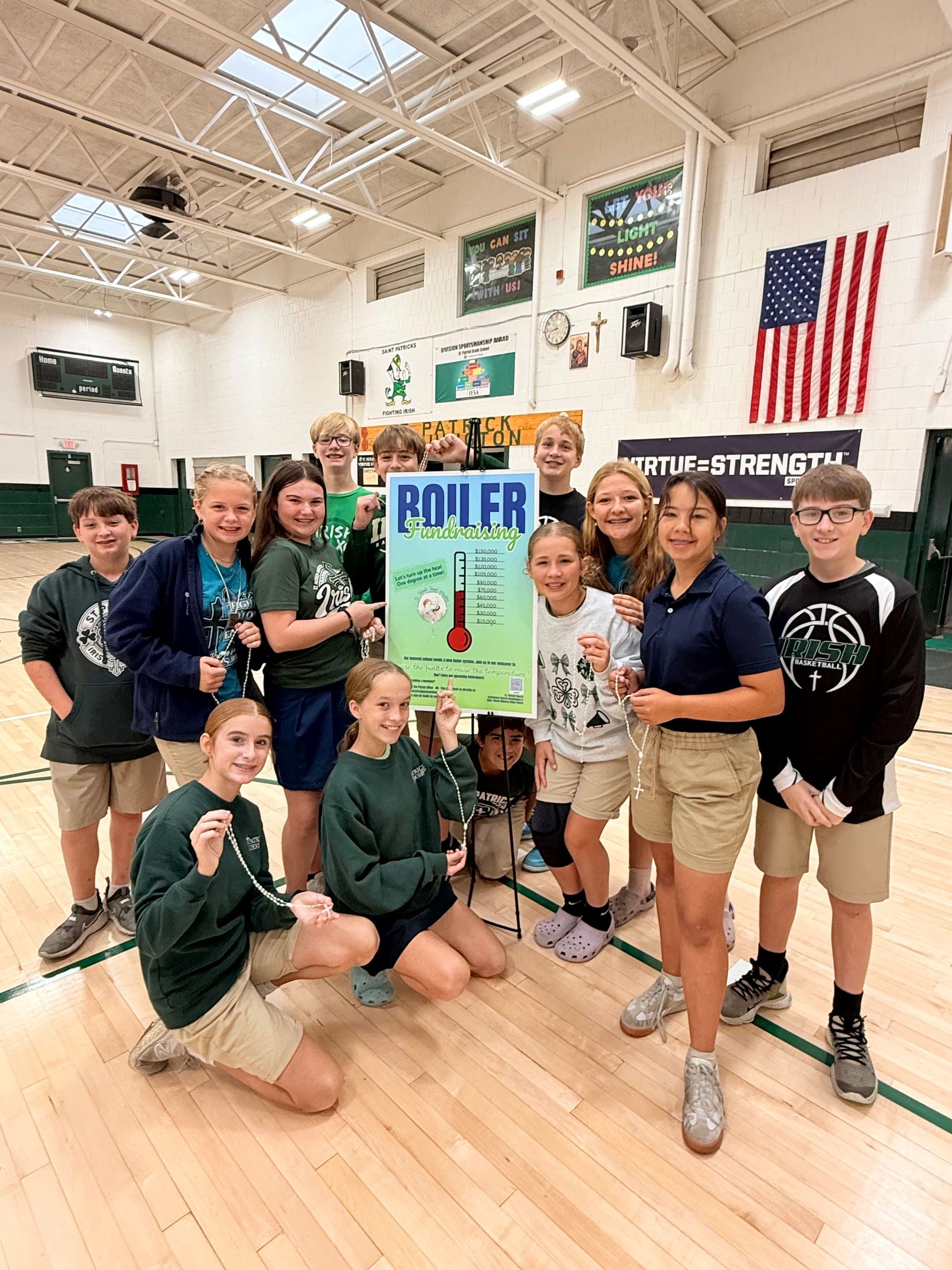 Students in a gym hold a