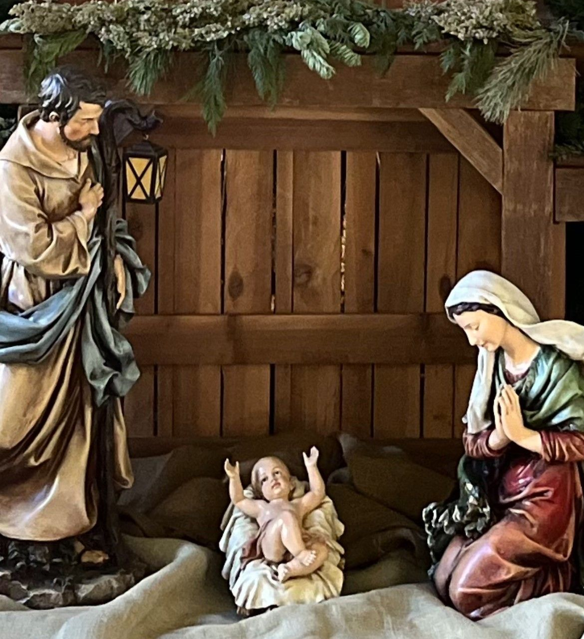 Nativity scene: Joseph, Mary, and baby Jesus in a manger.