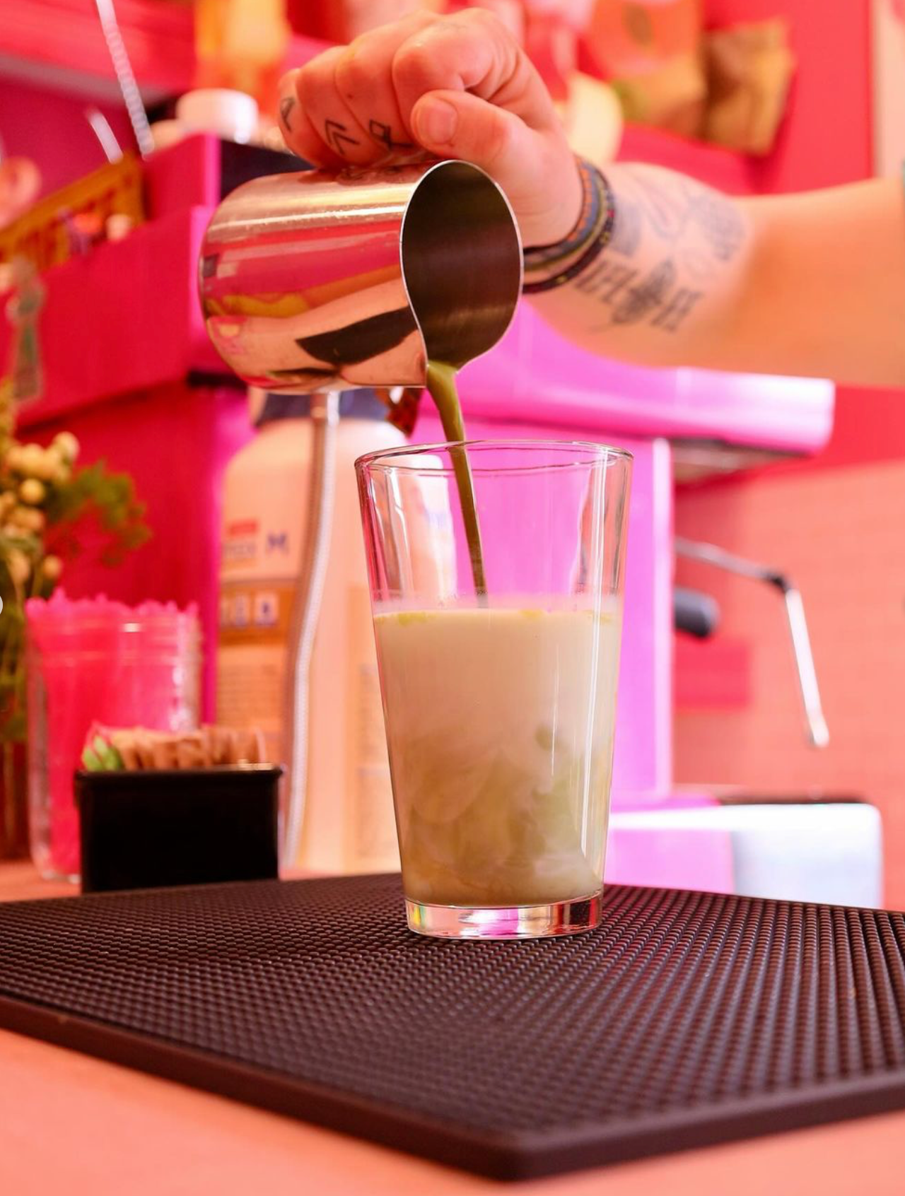 A person is pouring a drink into a glass.