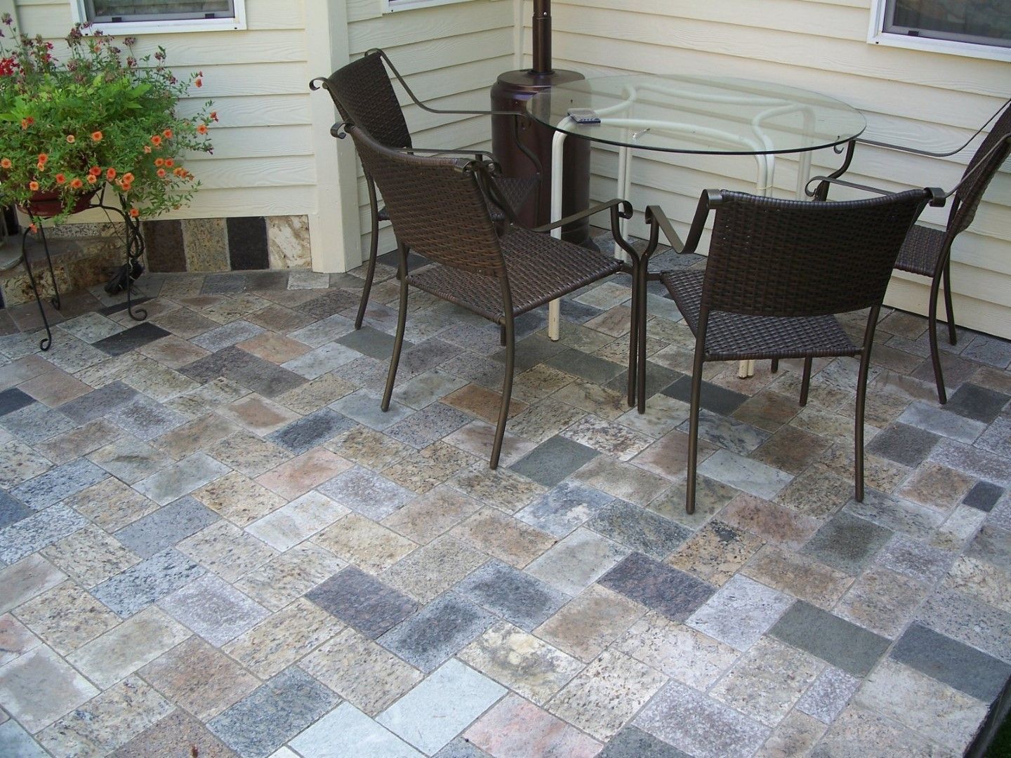 A patio with a table and chairs on it