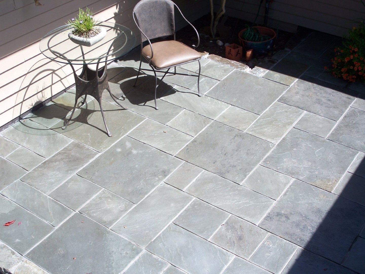 A patio with a table and chairs on it