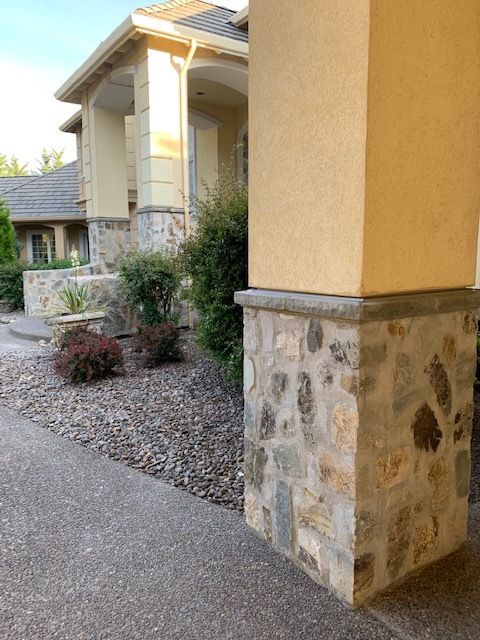 A house with a stone pillar in front of it
