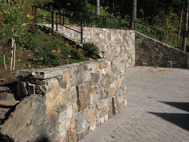 A stone wall with stairs leading up to it