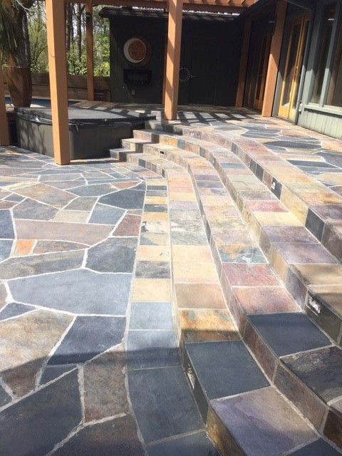 A stone patio with stairs leading up to it
