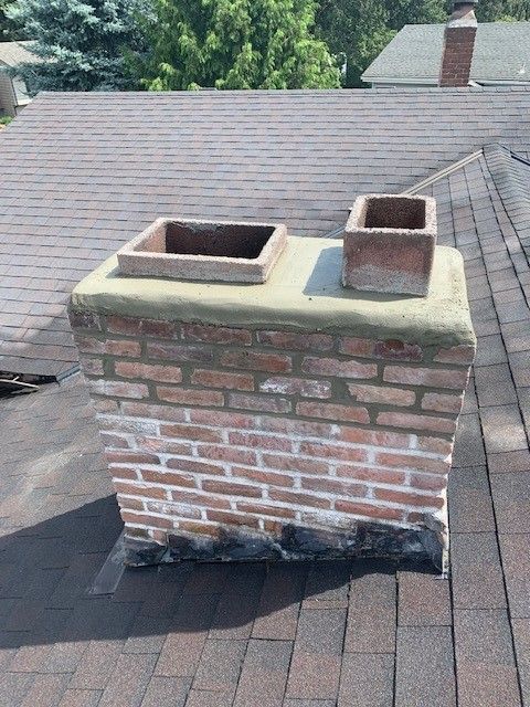 A brick chimney sitting on top of a roof