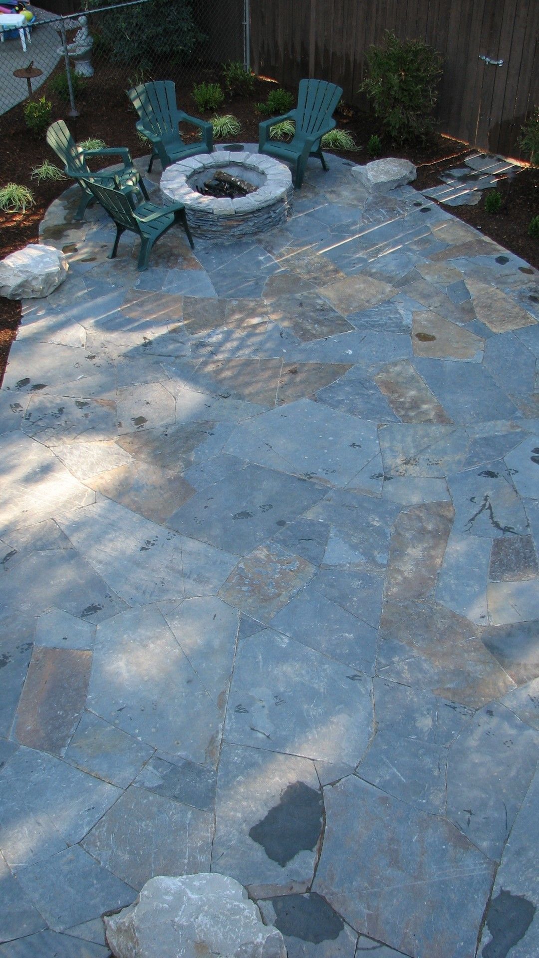 There is a fire pit in the middle of the patio.