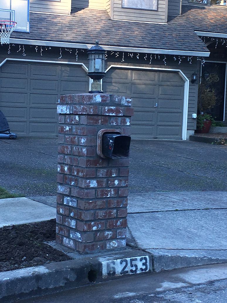 A brick post with the number 253 on it