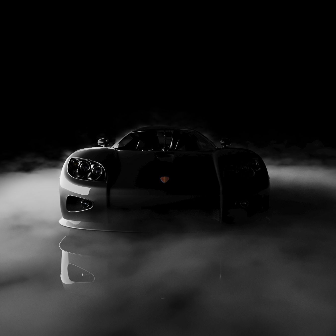 Black sports car emerging from fog.