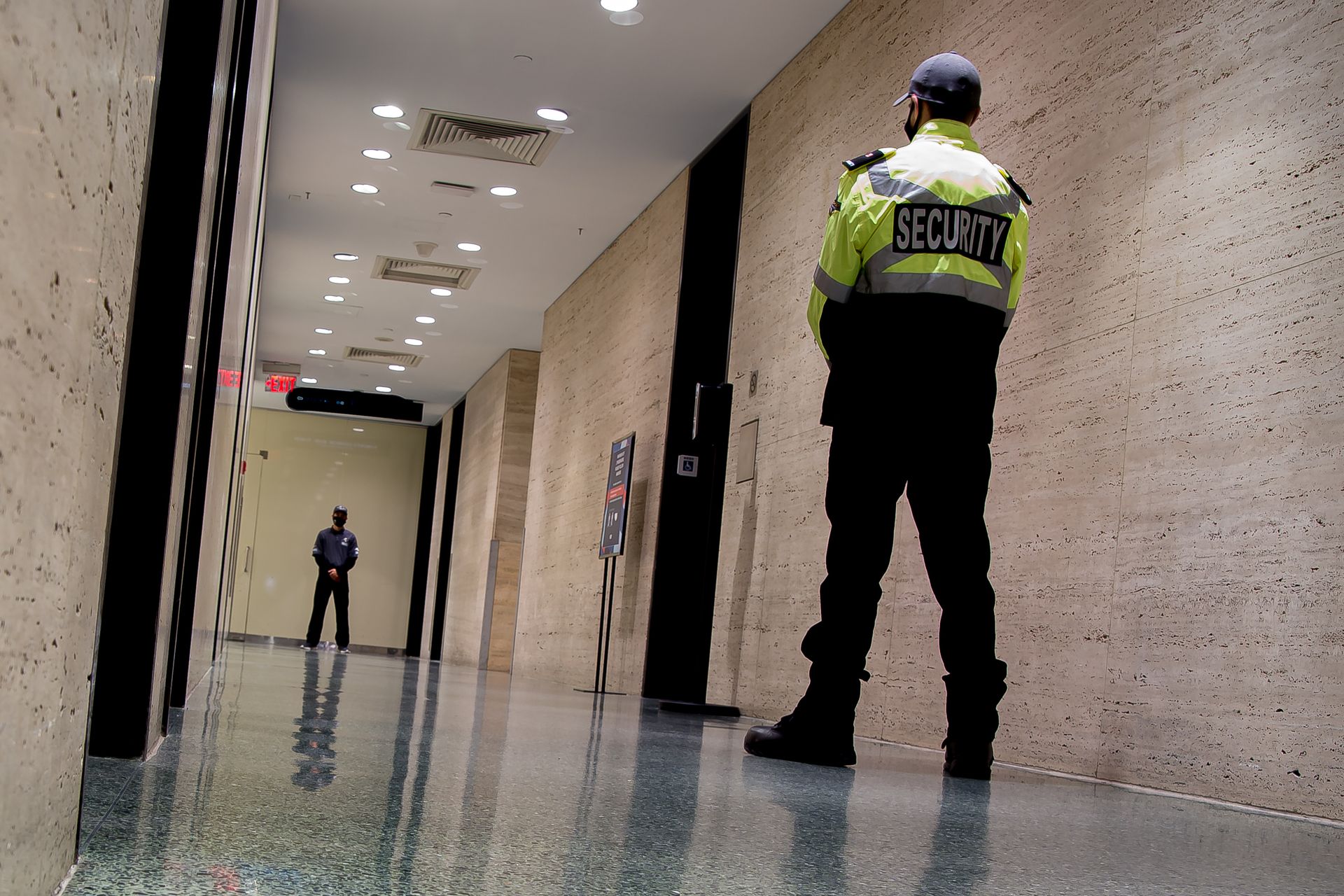 Two security guards in a commercial building. Two security guards in a commercial building.