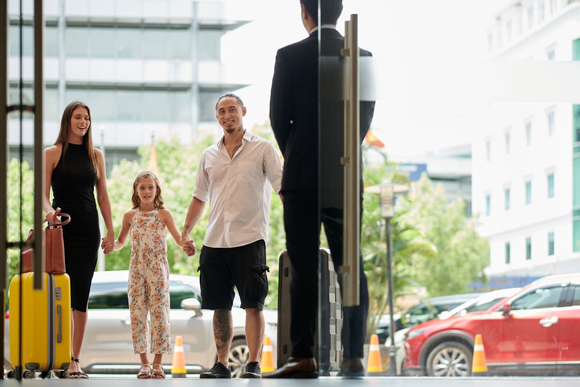 Family talking to concierge in the entrance hall of a hotel. Family talking to concierge in the entrance hall of a hotel.