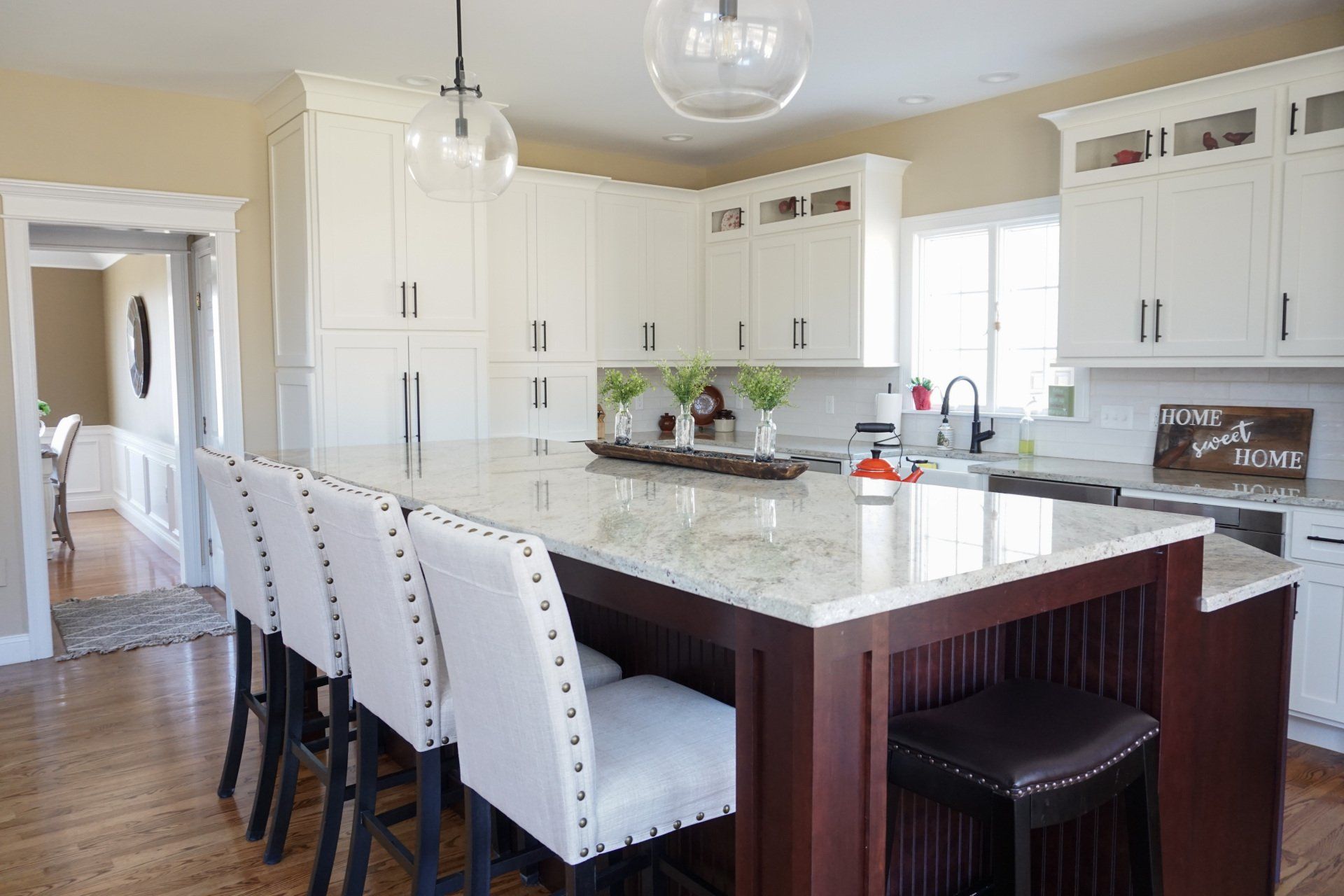 beautiful and classic kitchen remodel with marble island, dark stained wood and white cabinets