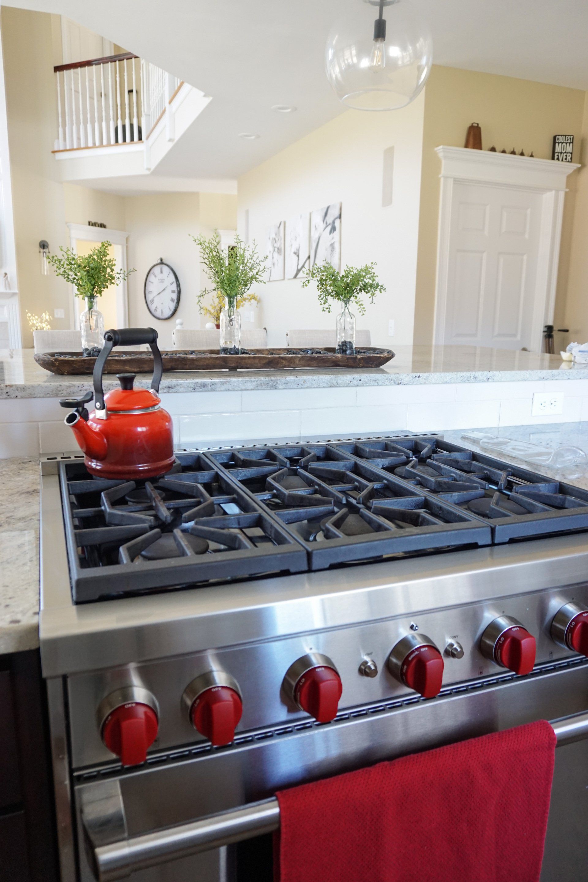 a red tea kettle is sitting on top of a stove in a kitchen remodel in Western Massachusetts
