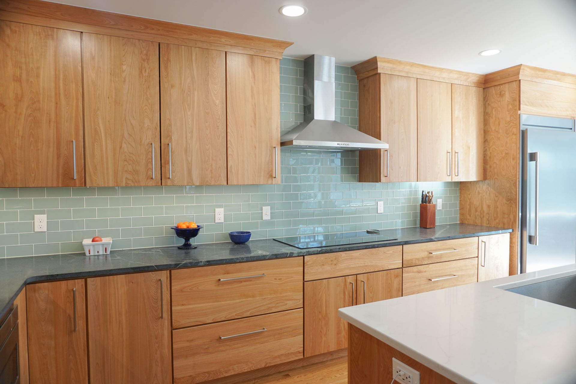 Modern kitchen with wooden cabinets, blue tile backsplash, kitchen by Chapdelaine Builders in East Longmeadow