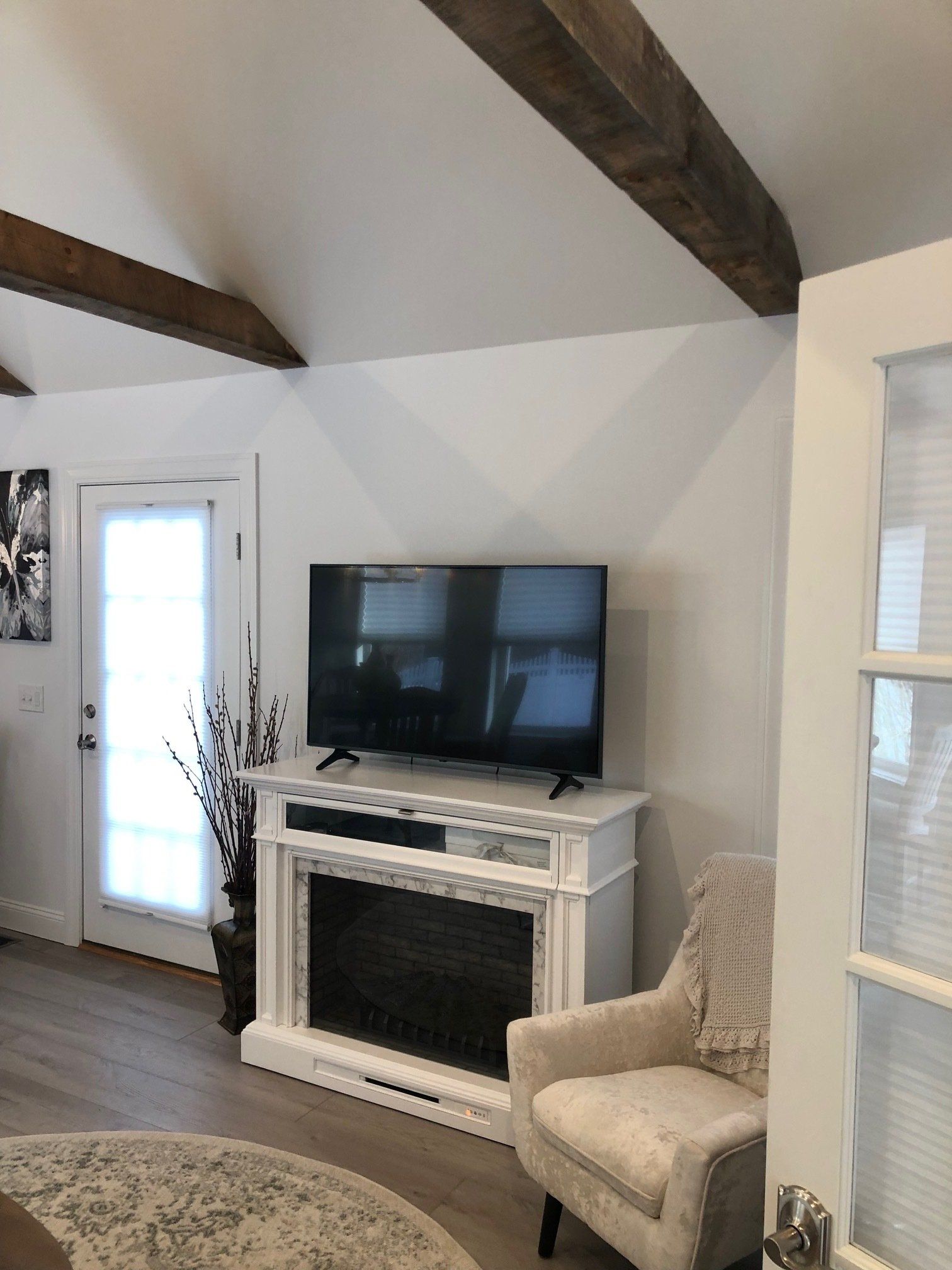 A living room with a fireplace and a flat screen tv