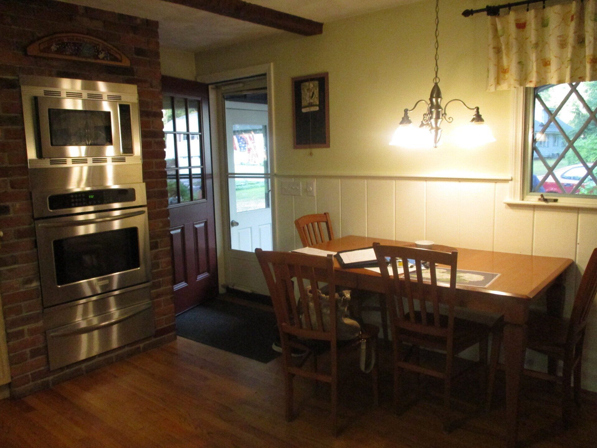 A kitchen with a table and chairs and a microwave