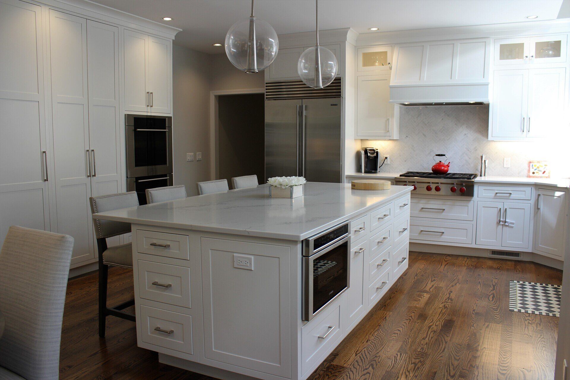 a kitchen with white cabinets and stainless steel appliances
