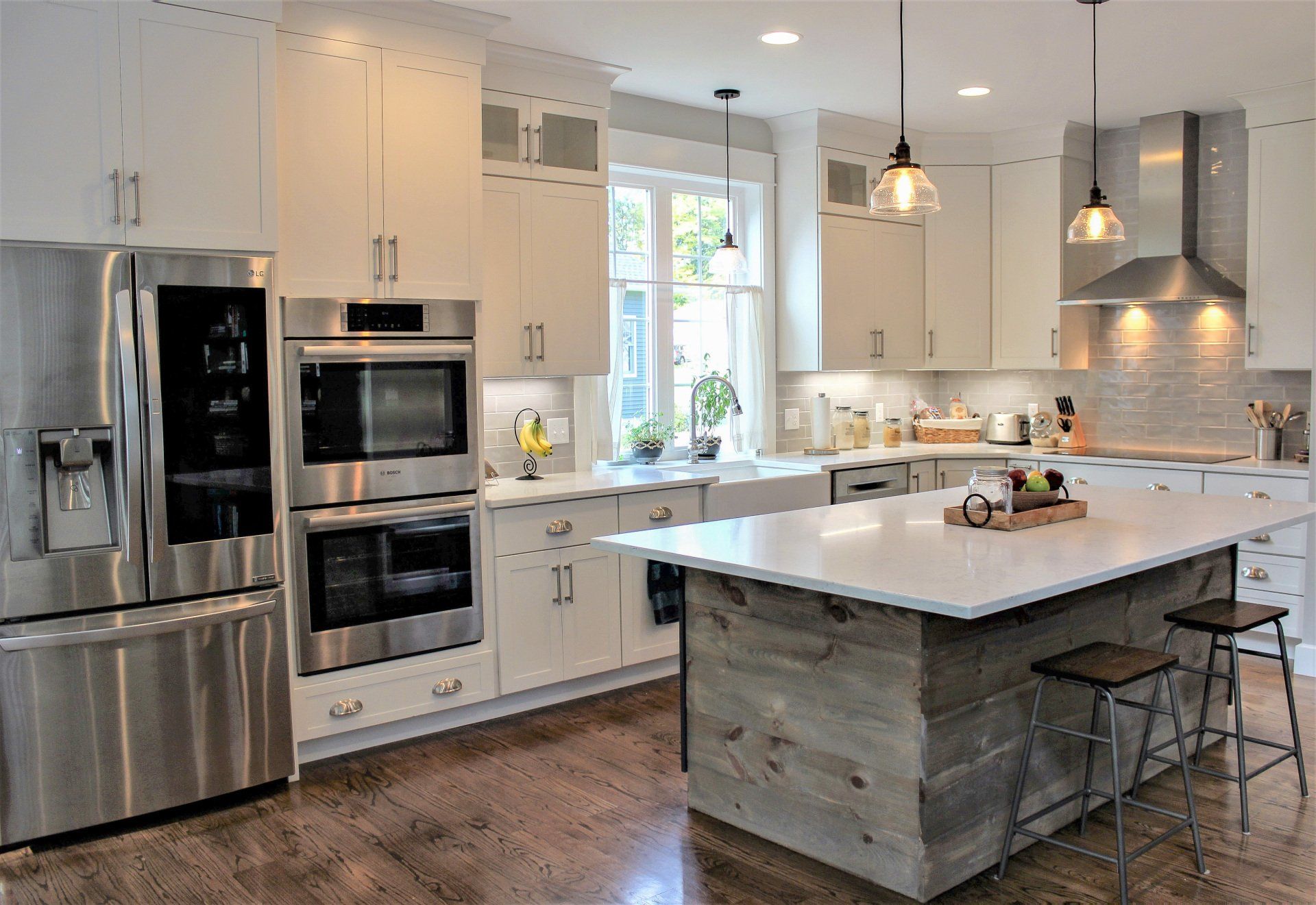 a kitchen with stainless steel appliances and white cabinets