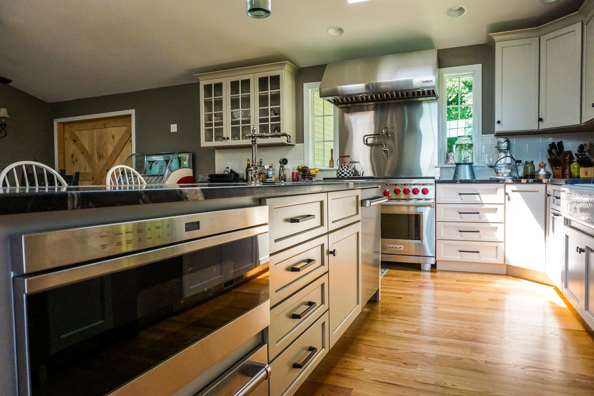 a kitchen with stainless steel appliances and white cabinets